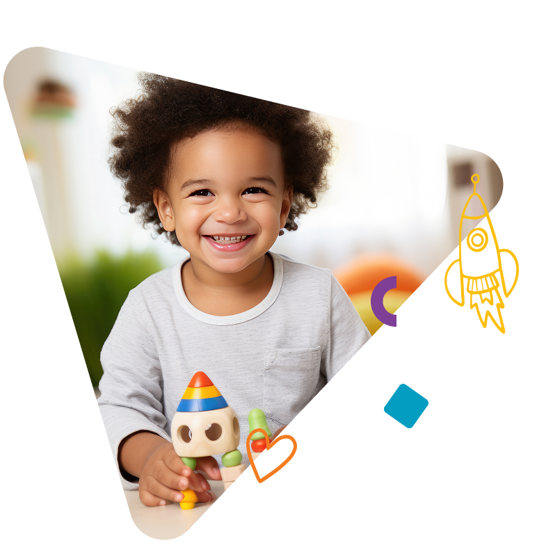 Boy smiling holding toy